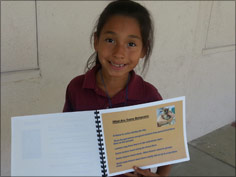 picture of one student holding her published book